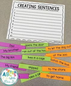 some writing paper with the words creating sentences on it and four pieces of stick