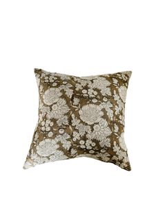 a brown and white pillow with flowers on it