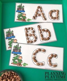 the letters and numbers are made up of nuts in front of a green tray with a bowl of peanuts