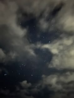 the night sky is filled with stars and clouds