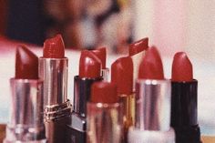 many lipsticks are lined up on a table