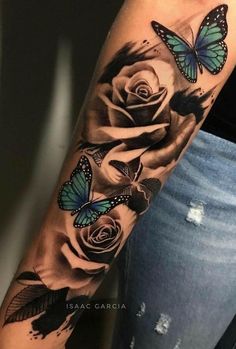 a woman's arm with roses and butterflies on it