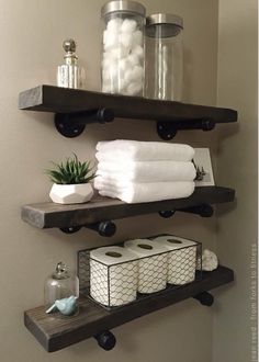 bathroom shelves with towels, soaps and other items on them in a home setting