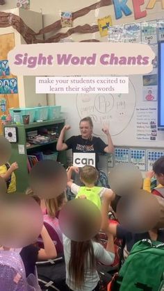 a man standing in front of a classroom full of kids with signs on the wall