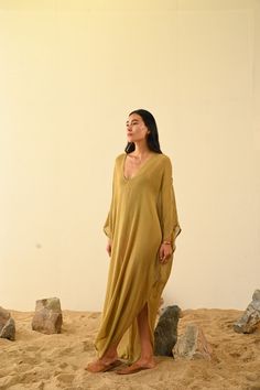 Jara Kaftan Raw Silk Gauze This handcrafted garment is made slowly with artisan techniques. Each piece is unique. One Size Care |  Dry clean or hang in soft sunlight or breeze to freshen. Please see care label Kaftan Outfits Women, Summer Silk V-neck Kurta, Bohemian Silk V-neck Dress For The Beach, Bohemian Silk V-neck Beach Dress, Bohemian V-neck Silk Beach Dress, Bohemian Gold Maxi Dress With Long Sleeves, Gold Kaftan For Summer Vacation, Long Sleeve Silk Beach Dress, Gold Bohemian V-neck Dress