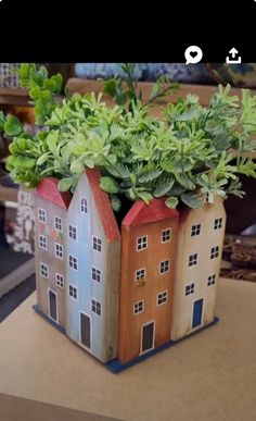 a small house planter sitting on top of a table