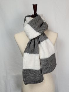 a gray and white scarf on a mannequin