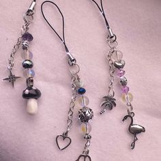 two necklaces with charms hanging from them