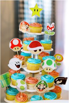 cupcakes are arranged in the shape of a mushroom on top of a cake stand