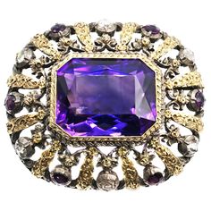 An amazing amethyst measured to weigh approximately 30 carats is the centerpiece of this incredible antique brooch. The faceted, extremely well-cut Amethyst displays a unique color saturation of deep, bright purple with slight shimmers. The Amethyst is set in a hand-crafted setting of silver and gold and embellished with bright and sparkling smaller amethysts and rose-cut diamonds. The gorgeous design and detailed gold and silver work on this brooch are a testament to the true craftsmanship of t Antique Brooches, Diamond Brooch, Gold Brooches, Silver Work, Antique Roses, Silver Brooch, Vintage Jewels, Rose Cut Diamond, Vintage Jewellery