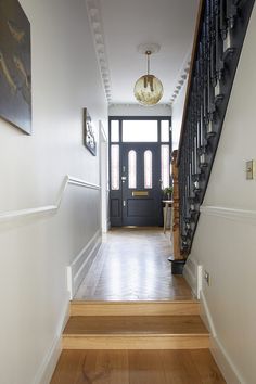 an entryway with stairs leading up to the door and another room on the other side