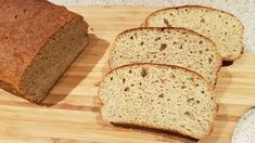 slices of bread sitting on top of a wooden cutting board