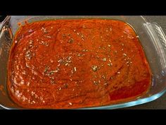 a glass casserole dish filled with red sauce