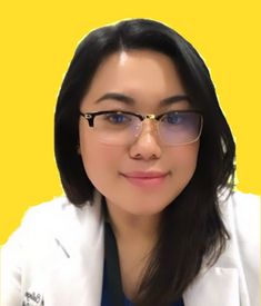 a woman wearing glasses and a white jacket with a yellow background is looking at the camera