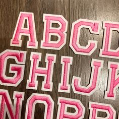 the letters are made out of felt and have been cut into smaller pieces to make it look like they are in different sizes