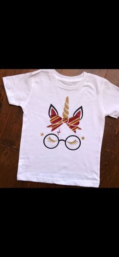 a white t - shirt with an image of glasses and a unicorn's horn on it