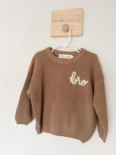 Welcome to indigo + rainn co. ! This listing is for this pre-made, ready to ship 'bro' embroidered sweater. The sweater is in size 2T and it fits oversized. It is a mocha brown colored sweater with 'bro' embroidered in white yarn. Please note, this is a pre-made item and does not come with any customization. This is the only sweater of this design available. If you would like a similar custom design, message me to go over pricing and design options. :) I can't wait to see one of your littles wearing this adorable sweater! Follow my shop on Instagram @indigorainnco and tag me in your photos with your indigo + rainn co. sweater!  *Wash Care Fold garment inside out, wash on cold, gentle cycle, alone or with few items of like colors. For best results let air dry. *Returns I do not accept retur Neutral Sweaters, Toddler Sweater, Kids Jumpers, Embroidered Sweater, Gifts For Brother, Kids Sweater, Girls Sweaters, Chunky Yarn, Baby Sweaters