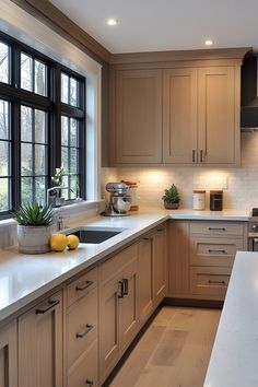 a large kitchen with wooden cabinets and white counter tops, along with black framed windows