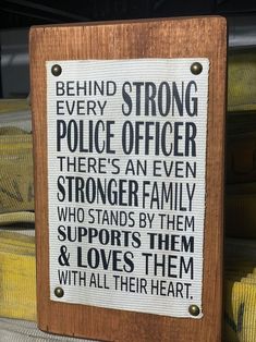 a sign that is on the side of a building saying behind strong police officer there's an even shorter family who stands by them and loves them with all their heart