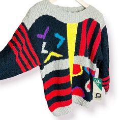 a colorful sweater hanging on a clothes hanger with an air plane design painted on it