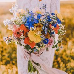 a woman holding a bouquet of flowers in her hands