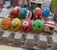 an assortment of painted eggs with faces on them