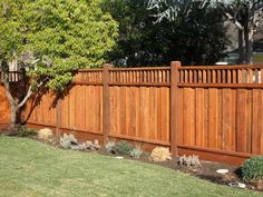 a wooden fence in the middle of a yard