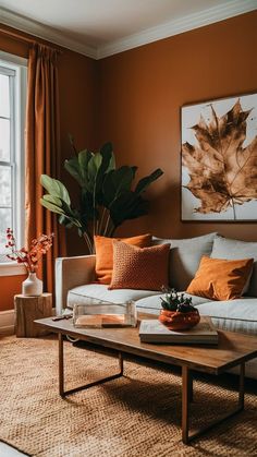 a living room with an orange wall and white couches in front of a window