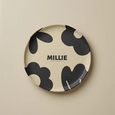 a black and white plate with the word millie on it