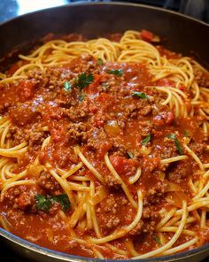 a pan filled with spaghetti and meat sauce