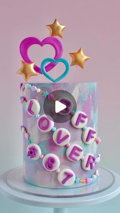 a birthday cake with the words love is spelled out on top and stars around it