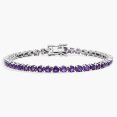 Brilliant purple amethysts shimmer as this timeless tennis bracelet catches the light. The 3mm-wide sterling silver design promises enduring quality and the cool gleam complements the stones. Elegant Silver Tennis Bracelet With Amethyst, Elegant Silver Amethyst Tennis Bracelet, Elegant Silver Tennis Bracelet, Anniversary Amethyst Gemstone Tennis Bracelet, Elegant Sterling Silver Round Amethyst Bracelet, Elegant Purple Sterling Silver Jubilee Bracelet, Elegant Round Amethyst Sterling Silver Bracelet, Classic Purple Tennis Bracelet As A Gift, Purple Tennis Bracelet For Anniversary