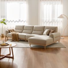 a living room with a sectional couch and coffee table