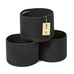 three black round baskets sitting on top of each other