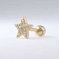 a pair of yellow gold plated silver earrings with white and clear crystal stones in the shape of a star