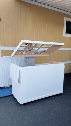 a white storage box sitting in front of a house