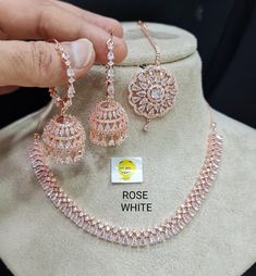 a necklace and earring set on display in a store