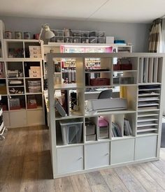 a room filled with lots of books and office supplies