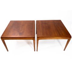 two wooden tables sitting side by side on top of each other with one end facing the other