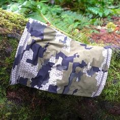 a bag sitting on top of a moss covered log