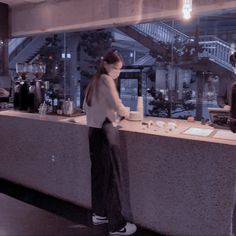 two people standing in front of a counter