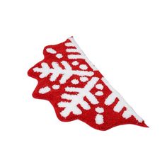 a red and white snowflake pattern on the side of a piece of fabric