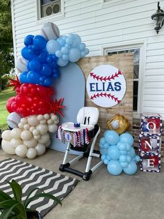 balloons and decorations are on the front porch of a house for a baseball themed birthday party