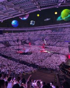 a large crowd at a concert in an arena