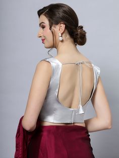 Item Type: Saree blouse / Crop top Product Features: Color: Silver Fabric: Cotton Satin Stretch Blend Trim: Back Tie Neck Style: U-Neck, Front & Back Sleeve Length: Sleeveless Closure: Back Hook Padded: No Product Type: Blouse Disclaimer: There will be slight difference in digital to actual image Elegant Sleeveless Crop Top, Fitted Silver Sleeveless Crop Top, Elegant Fitted Sleeveless Crop Top, Party Vest Blouse, Elegant Stretch Crop Top Blouse, Stretch Tank Blouse For Party, Padded V-neck Tank Top, Silver Fitted Sleeveless Halter Top, Chic Silver Sleeveless Top