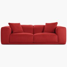 a red couch sitting on top of a white floor