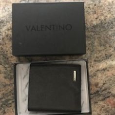 Authentic Valentino By Mario Bi -Fold Leather Wallet In Dark Brown. This Luxurious Wallet Features 6 Card Slots, 2 Bill Compartments, Inside Compartments For Extra Cards Etc, One Change Pocket With Snap Closure, Silver Tone Valentino Logo Hardware And With Logo Patch Design Inside. This Wallet Is Almost Brand New With Box. Purchased In Venezia, Italy In 2018. Please See Pictures For Additional Description Venezia Italy, Valentino Logo, Valentino Designer, Shoe Bags For Travel, Mario Valentino, Chip Bags, Leather Bifold Wallet, Valentino Bags, Patch Design