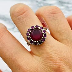 ✨Ruby Women's Ring with Flower Pattern - Handmade Turkish Jewelry This elegant ring blends the elegance of Ottoman design with modern craftsmanship. Crafted in 925 sterling silver, the vibrant ruby stone at the center of this ring adds a pop of color to any outfit. the floral pattern adds a feminine and sophisticated touch. Whether you are looking for a unique piece for yourself or a thoughtful gift for someone special, this ring is sure to impress. Carefully handcrafted, this ring is a true wor Formal Gemstone Flower Ring, Classic Round Gemstone Flower Ring, Formal Sterling Silver Ruby Ring With Halo Design, Silver Sterling Ruby Ring With Halo Design, Silver Ruby Ring With Halo Design In Sterling Silver, Ruby Ring With Halo Setting As Gift, Sterling Silver Ruby Ring With Halo Design, Sterling Silver Ruby Ring With Halo Design For Gift, Handmade Round Sapphire Ring For Formal Occasions