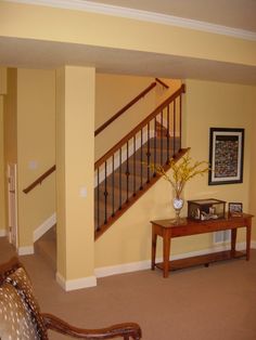 a living room filled with furniture and a stair case