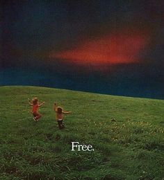 two children running across a green field with the sky in the background and an advertisement for free